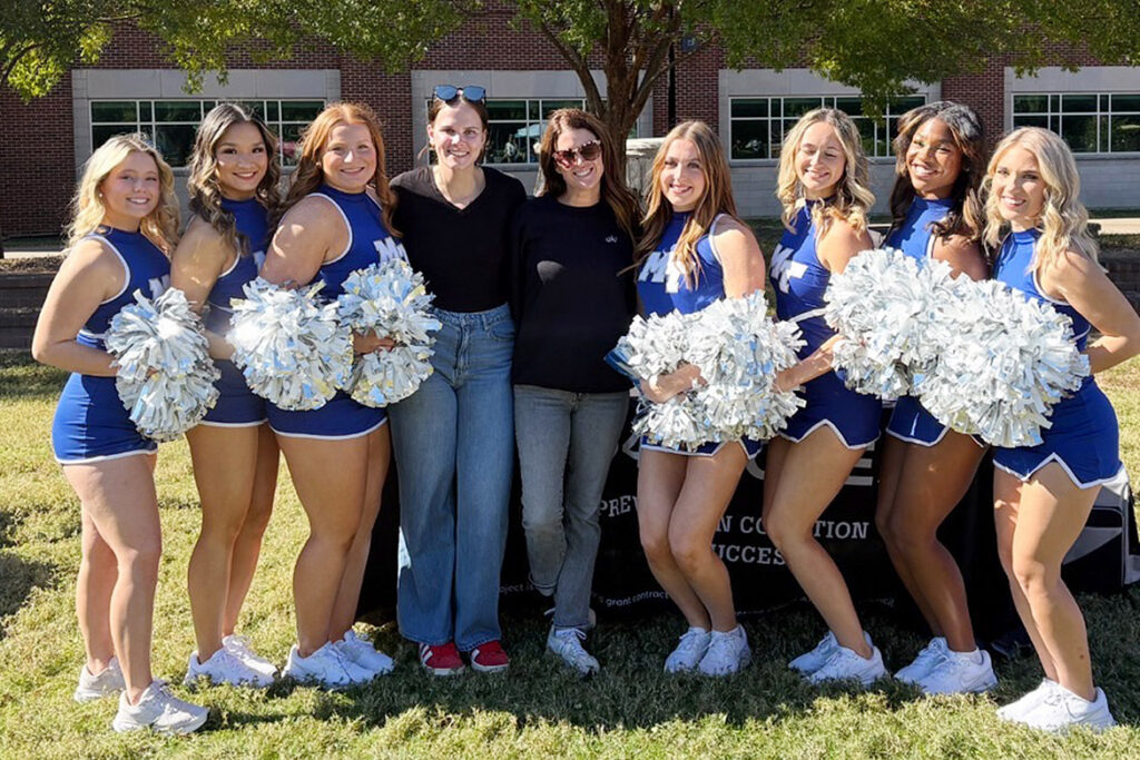 Morgan Verdeck, center left, and Katherine Prince, center right, from Rutherford County-based nonprofit Prevention Coalition for Success, pose with cheerleaders from Middle Tennessee State University in Murfreesboro, Tenn., during the Meet Murfreesboro tabling event held on campus on Aug. 25, 2026. The Coalition is partnering with MTSU to host True Blue Peers 4 Success, a peer recovery group to support students and promote mental health. (Submitted photo)