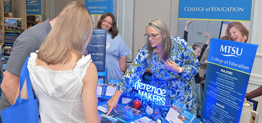 Tiffany Fantine, right, director of advising for the College of Education at Middle Tennessee State University in Murfreesboro, Tenn., discusses opportunities with future Blue Raiders at the university’s True Blue Tour student recruitment stop held Sept. 14, 2026, at the Franklin Marriott Cool Springs in Franklin, Tenn. Looking on, back center, is Molly Mihm, the college’s graduate program recruiter. (MTSU photo by James Cessna)