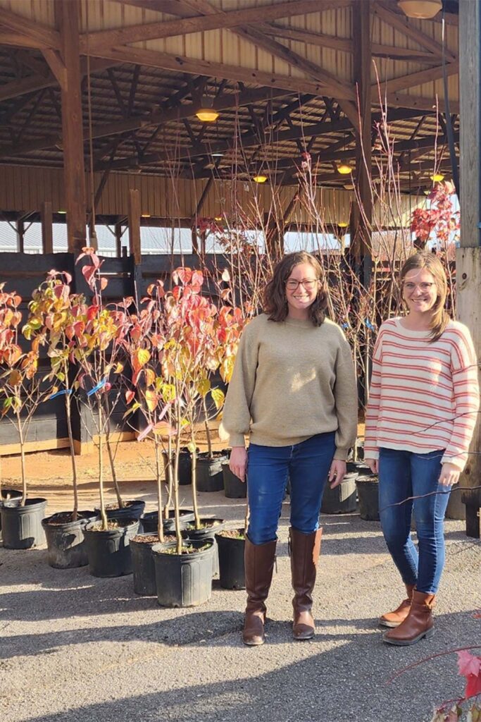 Kristin England, left, and Kristen Hargis, manager and assistant manager for the Center for Energy and Sustainability at Middle Tennessee State University in Murfreesboro, Tenn., stand at the “Plant a Bigger Tree for Tennessee” pickup on campus during the inaugural sale in 2025. (Submitted photo)