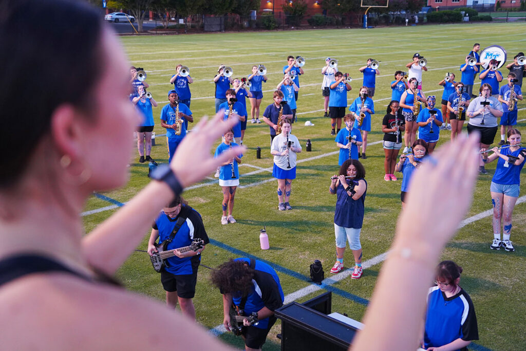 Kayla Ownby, a drum major for the Middle Tennessee State University Band of Blue, directs the band during a selection on the final evening of band camp Aug. 21, 2026, on campus in Murfreesboro, Tenn. Band members spent the weeks leading up to the fall semester rehearsing music and preparing for the upcoming football season. (MTSU photo by Mike Davis) 