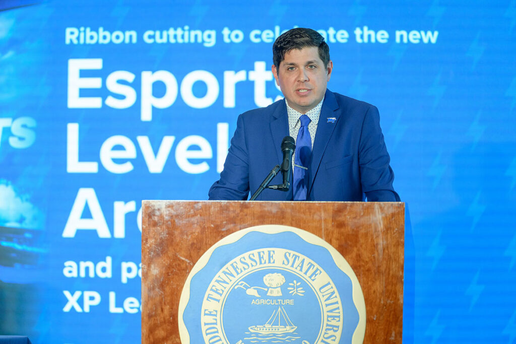 Justin Reed, executive director of administration and strategic initiatives for the Student Affairs Division at Middle Tennessee State University, addresses attendees at the ribbon-cutting and partnership signing ceremony in the Student Union Building atrium for the newly expanded Esports Level Up Arena located on the first floor of the building on the Murfreesboro, Tenn., campus. (MTSU Photo by J. Intintoli)