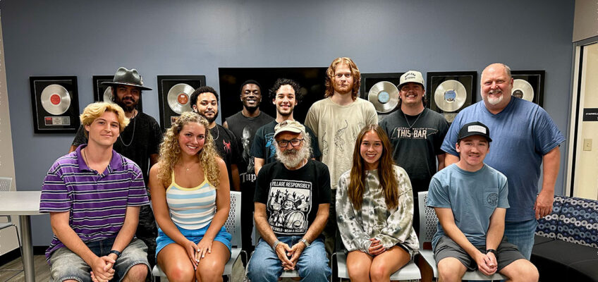 Hall of Fame songwriter Kostas Lazarides, known professionally as Kostas, front center, spoke to an advanced commercial songwriting class taught by Middle Tennessee State University assistant professor and songwriter Odie Blackmon, back row right, on Sept. 8, 2026, in the Commercial Songwriting Center inside the Miller Education Center on Bell Street just off the university’s main campus in Murfreesboro, Tenn. (Submitted photo)
