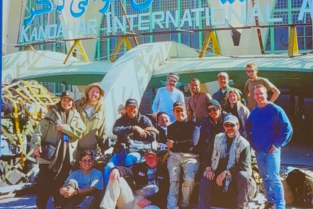 Retired Tennessean reporter and Middle Tennessee State University School of Journalism and Strategic Media professor Leon Alligood, third from right in the third row, pose for a photograph, outside of the Kandahar Airport in Kandahar City, Afghanistan, which served as a media hub for reporters covering the war. (Photo submitted)