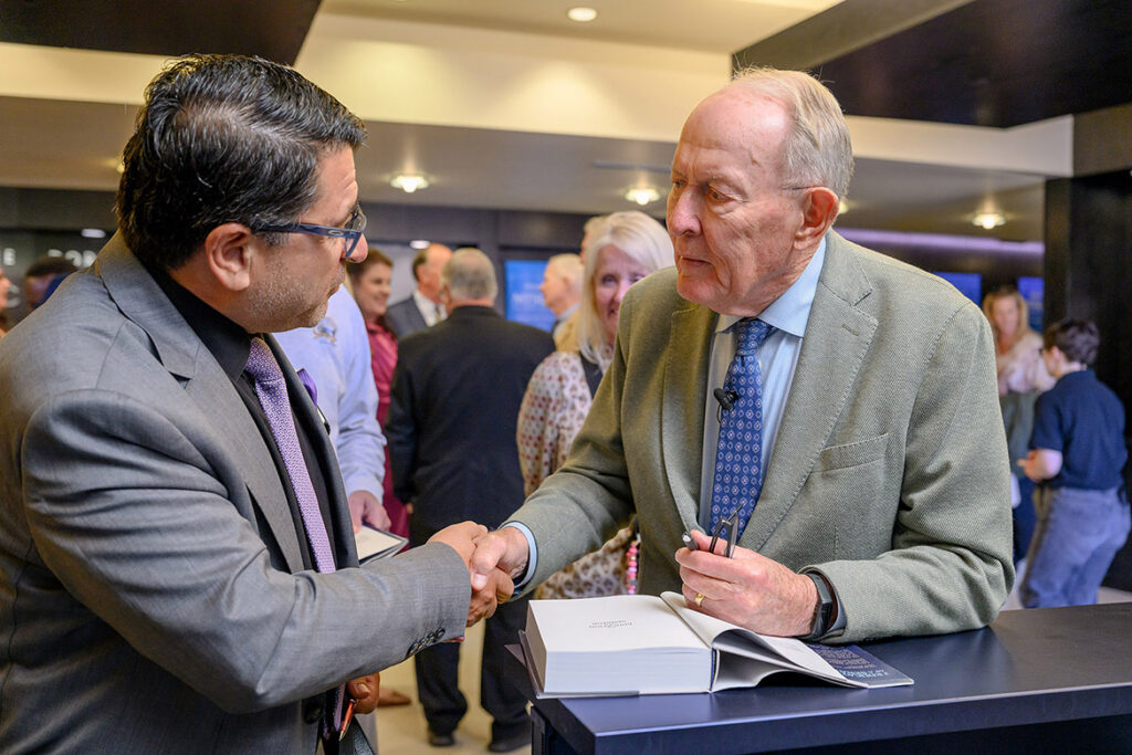 Murat Arik, professor of management and director of the Business and Economic Research Center at Middle Tennessee State University in Murfreesboro, Tenn., shakes hands with former Tennessee Gov. Lamar Alexander after signing his newly released memoir, “The Education of a Senator: From JFK to Trump,” following a conversational lecture with fellow former U.S. Sen. Bill Frist on the topic of “Leadership and Public Service” held Monday, Oct. 19, inside Tucker Theatre on campus. (MTSU photo by J. Intintoli)
