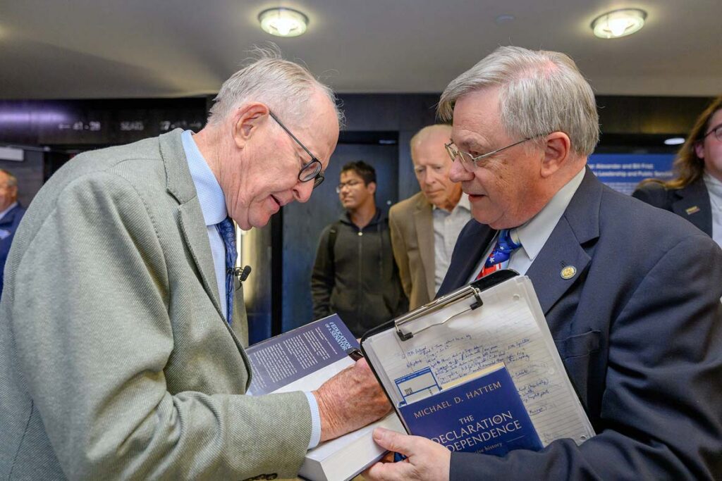 Former Tennessee Gov. Lamar Alexander, left, signs a copy of his new memoir, “The Education of a Senator: From JFK to Trump,” for John Vile, dean of the Honors College at Middle Tennessee State University in Murfreesboro, Tenn., following a conversational lecture with fellow former U.S. Sen. Bill Frist on the topic of “Leadership and Public Service” held Monday, Oct. 19, inside Tucker Theatre on campus. (MTSU photo by J. Intintoli)