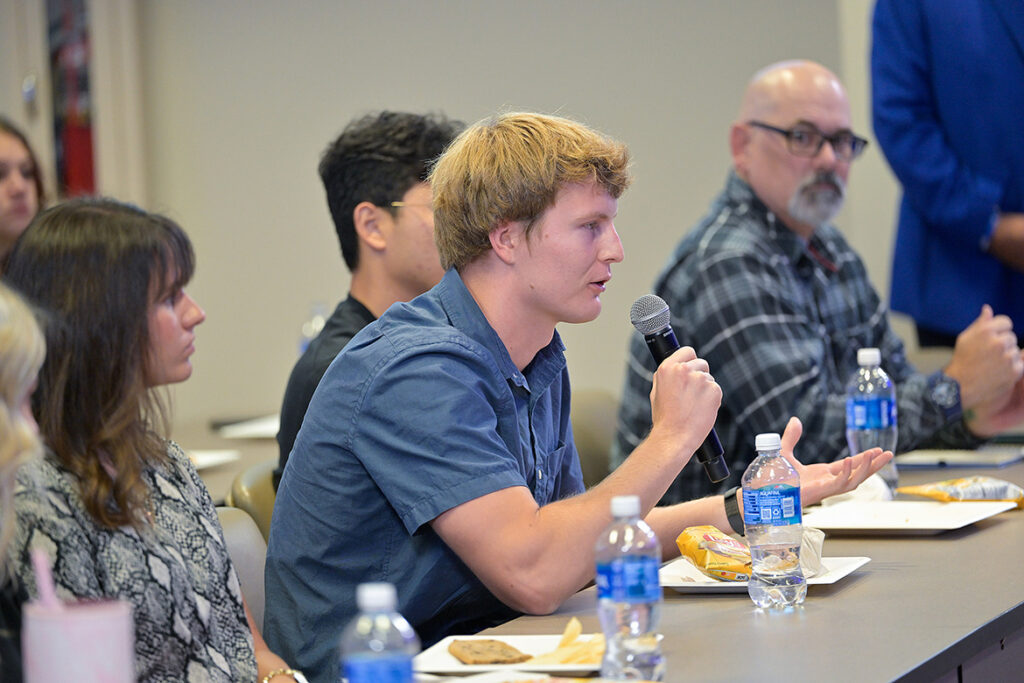A Middle Tennessee State University student asks panelists a question about establishing workplace and team culture during a live student coaching and Q&A session on Tuesday, Oct. 6, 2026, inside a second-floor meeting room of the Miller Education Center on Bell Street in Murfreesboro, Tenn. The panel was moderated by professor Colby Jubenville, director of the Center for Student Coaching and Success, and also featured center donors Eric Blankenship and John Floyd and MTSU men’s tennis coach Jimmy Borendame. (MTSU photo by Andy Heidt).