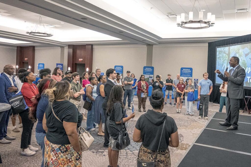 Students and their families from the greater Huntsville, Ala., area listen to Middle Tennessee State University President Sidney A. McPhee, on stage, talk about the more than 300 academic pathways and over $2 billion in improvements at the Murfreesboro, Tenn., campus during his 26-year tenure as part of the True Blue Tour student recruitment reception held on Wednesday, Oct. 14, at The Westin in Huntsville. (MTSU photo by Nancy DeGennaro)