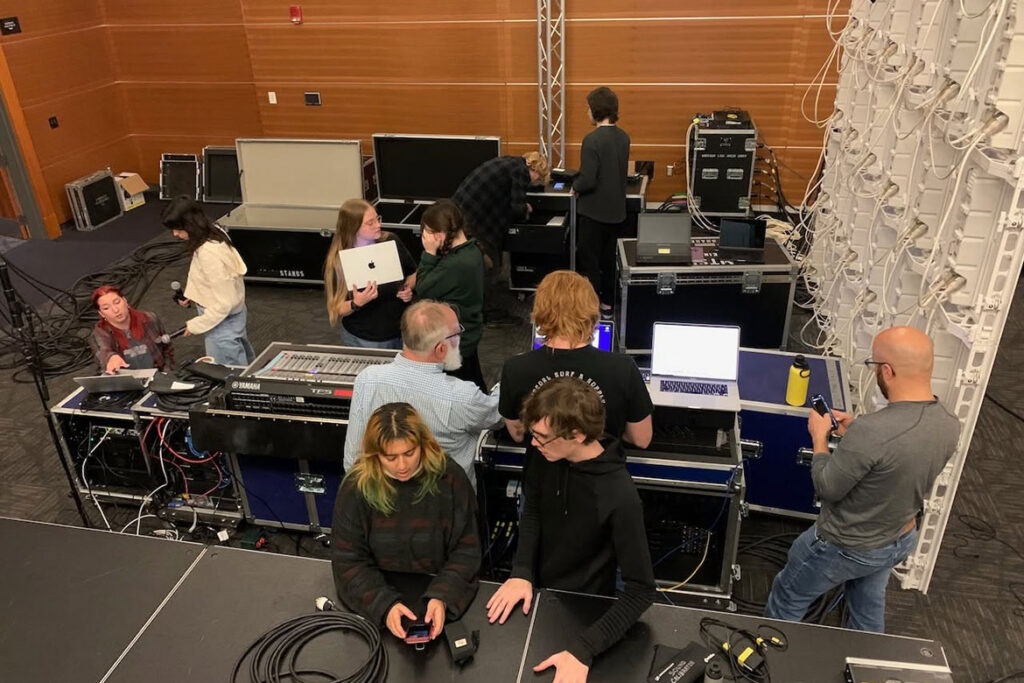 In this undated photo, Middle Tennessee State University Department of Recording Industry associate professor Frank Baird and his students set up sound for a concert in the Student Union Ballroom on the Murfreesboro, Tenn., campus. (Submitted photo)