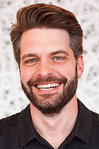 Bearded man smiling.