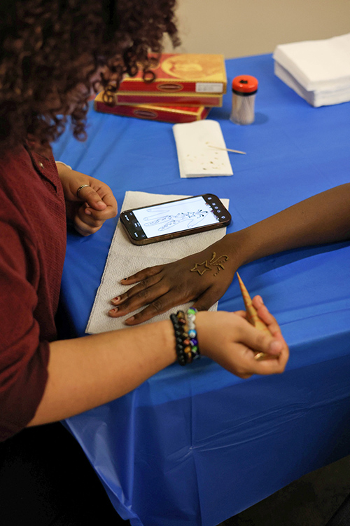 A henna artist does an intricate design on an attendee's hand at the SWANA (Southwest Asia and Northeast Africa) Culture Gallery, hosted at Middle Tennessee State University’s Tom Jackson Building on Oct. 5, 2026. Henna is a natural, plant-based dye originating in North Africa and the Middle East that is used for body art. (MTSU photo by Katelynn Liedtke)