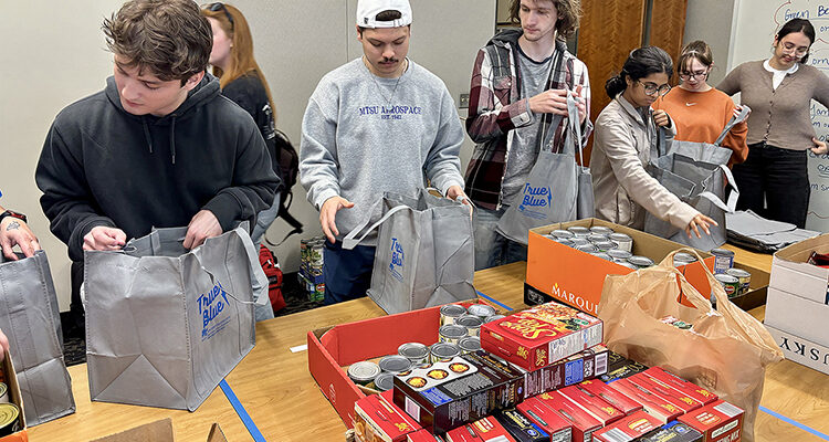 Students from the University Honors College Research Seminar class at Middle Tennessee State University in Murfreesboro, Tenn., assemble nonperishable items for Thanksgiving meal bags for students in need inside the Student Union on Wednesday, Nov. 5, 2025, in the Center for Student Involvement and Leadership at the Student Union Building on campus. (MTSU file photo by Nancy DeGennaro)