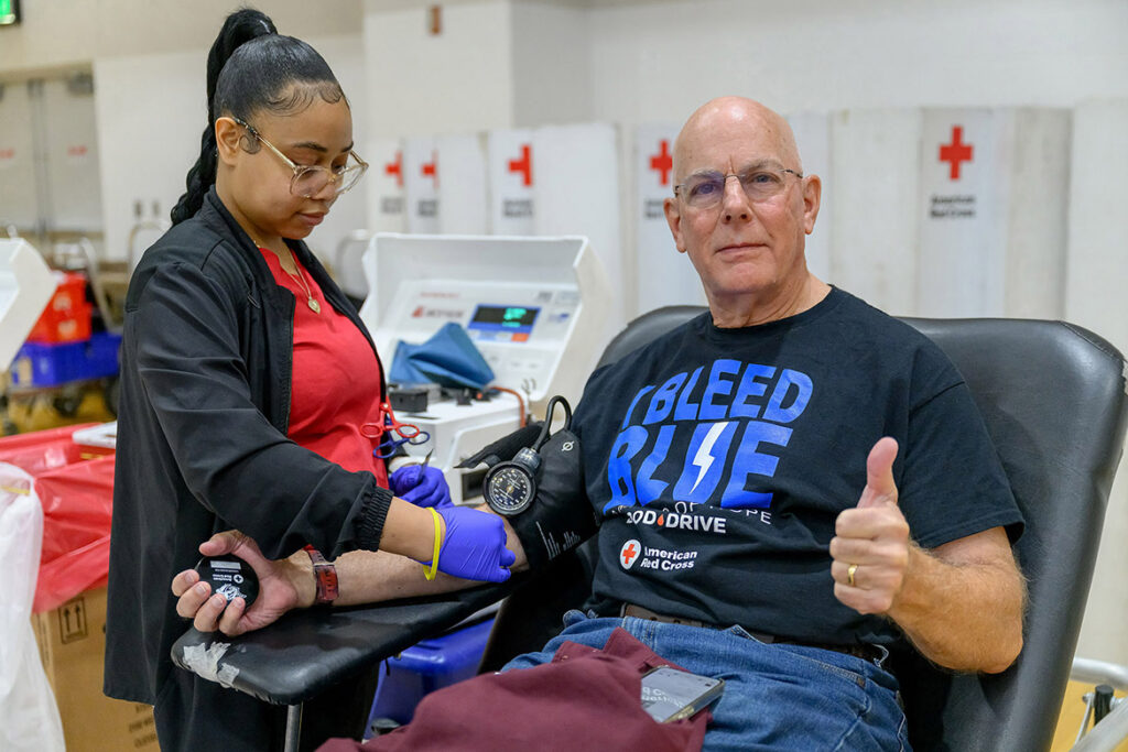 American Red Cross phlebotomist Moe Kearney, left, checks the vitals of blood donor Brad Miller during the 2025 “100 Miles of Hope” blood drive held in the Campus Recreation Center gym on campus at Middle Tennessee State University in Murfreesboro, Tenn. This year’s blood drive — a friendly rivalry between the MTSU Blue Raiders and Western Kentucky Hilltoppers — is set for 11 a.m. to 5 p.m. Monday-Wednesday, Nov. 2-4, in the same location. Whichever university garners the most donations in the three-day blood drive wins the coveted challenge trophy to display. (MTSU file photo by J. Intintoli)