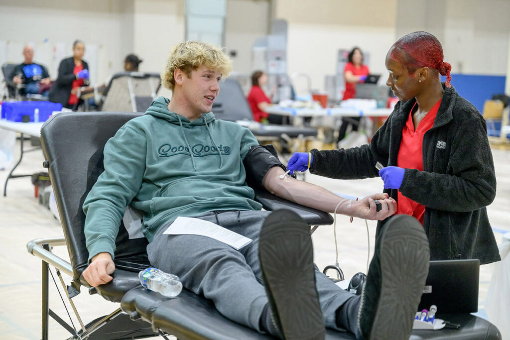 American Red Cross phlebotomist Zaria Spencer, right, preps Middle Tennessee State University student Evan Kirby for a blood donation during the 2025 “100 Miles of Hope” blood drive held in the Campus Recreation Center on campus in Murfreesboro, Tenn. This year’s blood drive — a friendly rivalry between the MTSU Blue Raiders and Western Kentucky Hilltoppers — is set for 11 a.m. to 5 p.m. Monday-Wednesday, Nov. 2-4, in the same location. Whichever university garners the most donations in the three-day blood drive wins the coveted challenge trophy to display. (MTSU file photo by J. Intintoli)