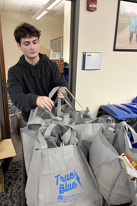 A student in the Honors College at Middle Tennessee State University in Murfreesboro, Tenn., sorts Thanksgiving meal bags that will benefit students in need on campus this holiday season. Student volunteers collected and assembled a total of 109 Thanksgiving meal bags inside the Student Union that were distributed Thursday, Nov. 6, 2025, as part of the First-Year and Nontraditional Student Engagement’s annual Thankful Thursday initiative. (MTSU file photo by Nancy DeGennaro)