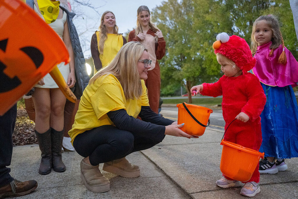 A tiny trick-or-treater grabs candy from a sorority member at Middle Tennessee State University in Murfreesboro, Tenn., during the 2025 Trick or Treat on Greek Row. Children ages 12 and younger are welcome to participate in this year’s free event, set for 5-7 p.m. Thursday, Oct. 29, in front of the sorority houses at Rutherford Boulevard and Alumni Drive campus. (MTSU file photo by Cat Curtis Murphy)
