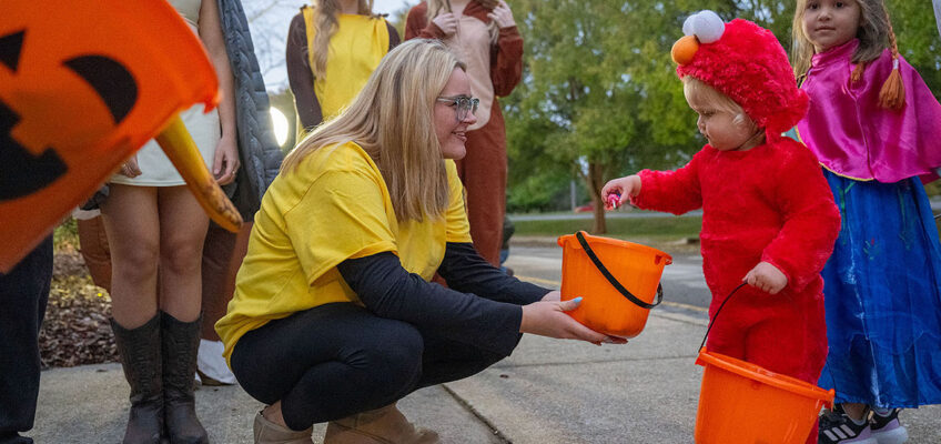 A tiny trick-or-treater grabs candy from a sorority member at Middle Tennessee State University in Murfreesboro, Tenn., during the 2025 Trick or Treat on Greek Row. Children ages 12 and younger are welcome to participate in this year’s free event, set for 5-7 p.m. Thursday, Oct. 29, in front of the sorority houses at Rutherford Boulevard and Alumni Drive campus. (MTSU file photo by Cat Curtis Murphy)