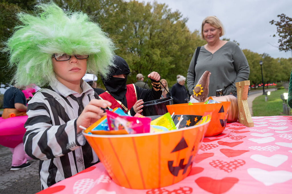 A young costumed Beetlejuice grabs candy from a sorority table at Middle Tennessee State University in Murfreesboro, Tenn., during the 2025 Trick or Treat on Greek Row. Children ages 12 and younger are welcome to participate in this year’s free event, set for 5-7 p.m. Thursday, Oct. 29, in front of the sorority houses at Rutherford Boulevard and Alumni Drive campus. (MTSU file photo by Cat Curtis Murphy)