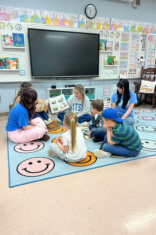 Middle Tennessee State University College of Education student Meredith Powers, center, reads to children during Literacy Night at Lascassas Elementary School located near the Murfreesboro, Tenn., campus. (Photo submitted)